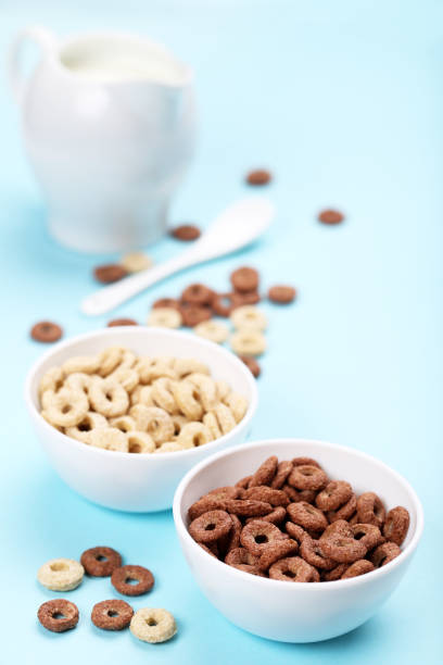 istock Various corn flakes with milk in jar on blue background 2125683475