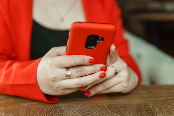 istock Mobile phone in female hands. Beautiful women's manicure 2125742628