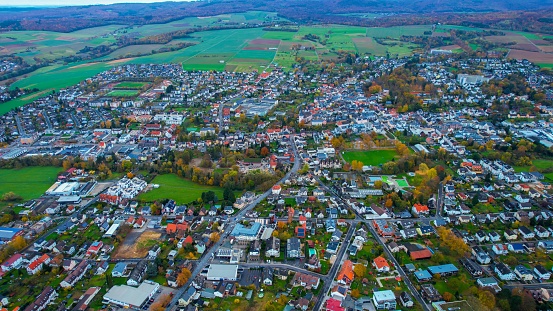 Aerial around the old town of the city Bad Camberg on a cloudy day in Fall in Germany