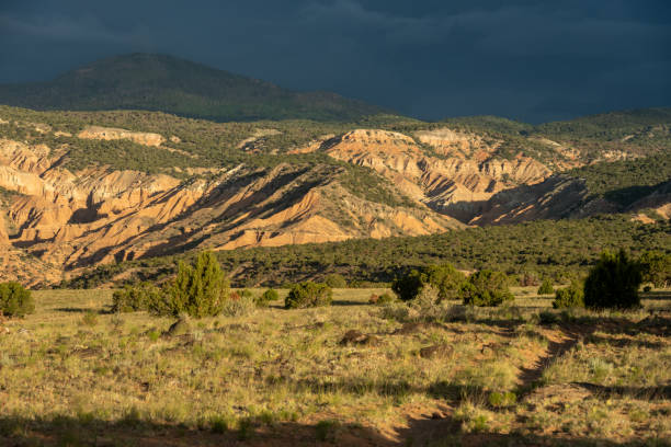 istock Dark Rain Clouds Cover Distant Ridge In Cathedral Valley 2125771634