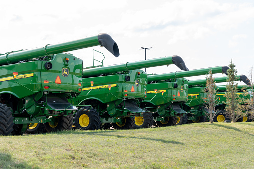 Many new John Deere agriculture and farming equipment displayed at a Brandt facility in Calgary, Canada, July 3, 2023.  John Deere is an American corporation that manufactures agricultural machinery.