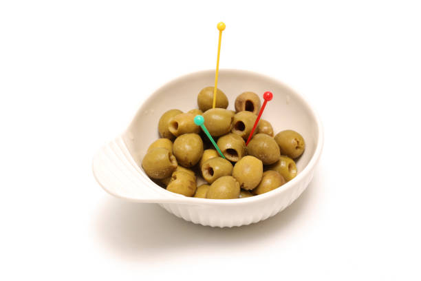 Pickled olives in a bowl isolated on a white background.