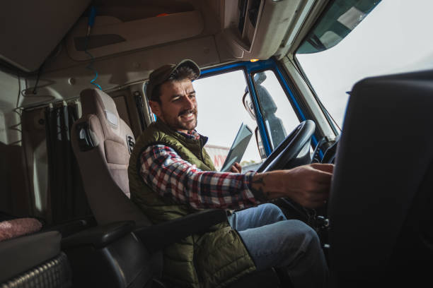 istock Happy confident male driver sitting in  his truck, using his tablet 2125855611