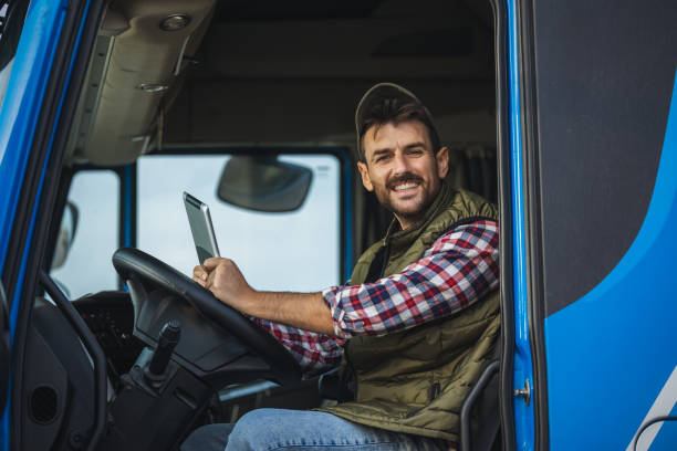 istock Happy confident male driver sitting in  his truck, using his tablet 2125858714
