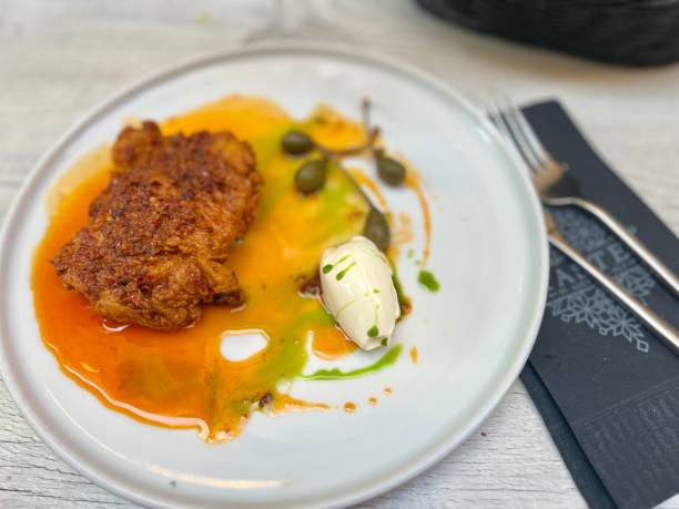 istock Buttermilk fried chicken and capers on white plate with honey butter at Valetta restaurant, Malta 2125889708
