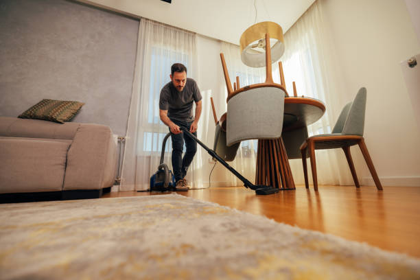 istock Man Keeping Home Clean with Vacuum 2125902675