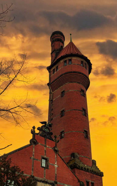 Old spooky brick water tower and purple setting sun