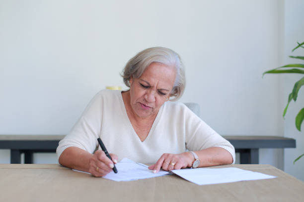 istock Thoughtful lady reviews important documents at home 2125974191