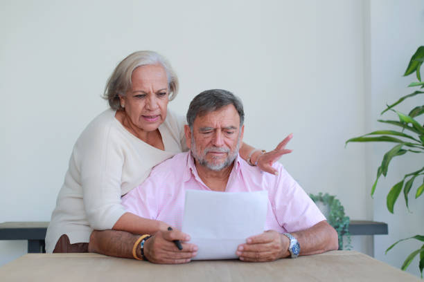 istock Senior couple value their banking returns at home 2125974710