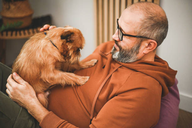 istock man with dog griffon bruxellois 2126046524