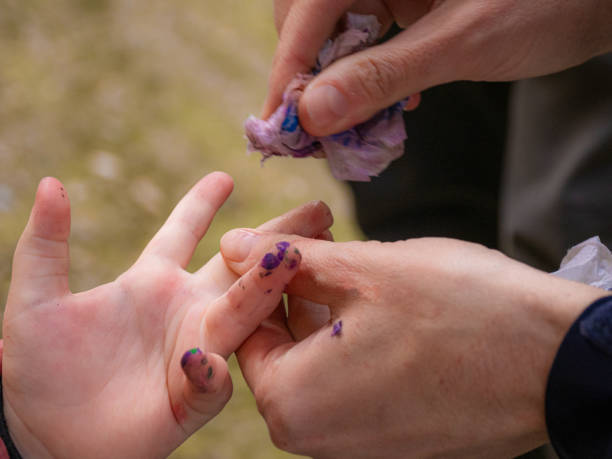 Cleaning a child's hands from paint