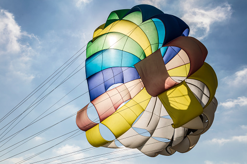 Colorful parasailing  parachute against blue sky