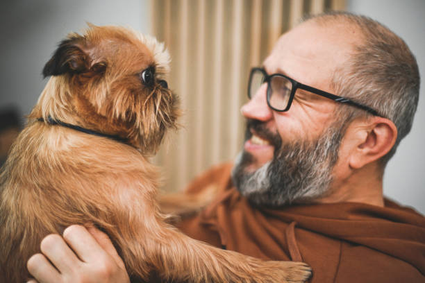istock man with dog griffon bruxellois 2126118532
