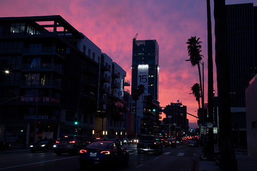 Los Angeles, California, USA-January 6, 2024: A colorful, unfiltered sunset turns the skies purple from a vantage point of Sunset Boulevard in the city of Hollywood. This busy street serves as a very well traveled destination northwest of downtown Los Angeles. (note: No color enhancements were made to this shot. All of this was in-camera)