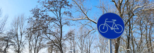 Banner with bike path sign on winter background.