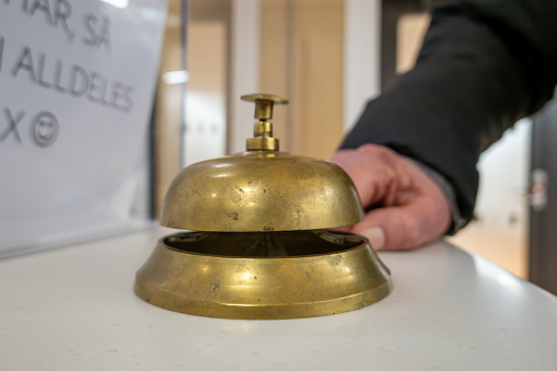 Stockholm, Sweden A bell in a reception area of a hospital and sign in Swedish says Sign in Here. .