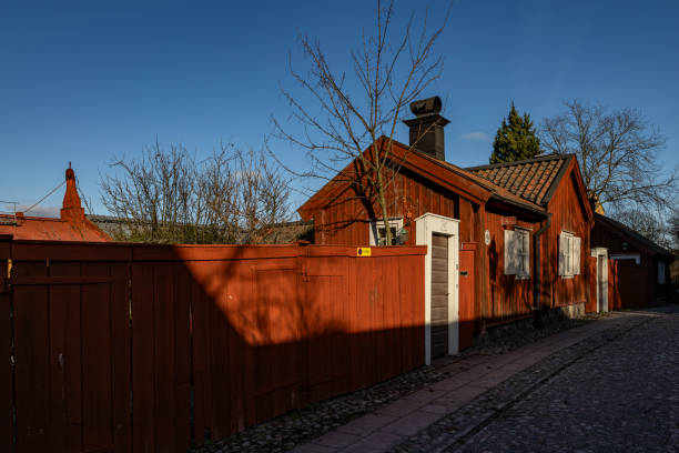 Old houses in the city of Västervik in Sweden. In the background is the church tower of Saint Gertrude's church.