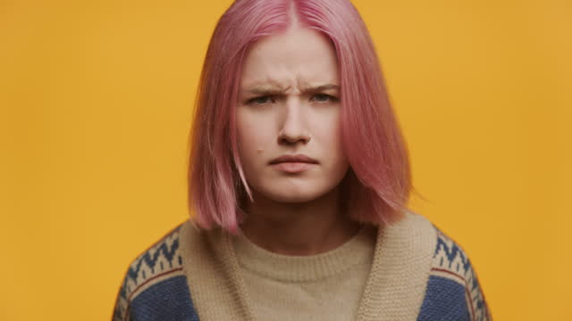 Pensive Questioned Young Woman with Pink Hair in Doubt