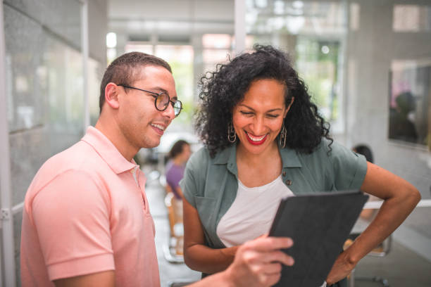 istock Cheerful Colleagues Strategizing A Business Plan On A Digital Tablet 2126220986