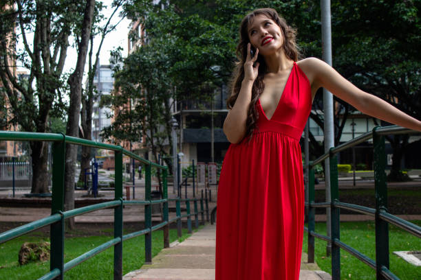 Young beautiful woman using cell phone in front of modern building