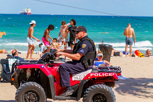 Fort Lauderdale, FL, USA - March 30, 2024: Senior police oficer on patrol Fort Lauderdale Beach Spring Break 2024