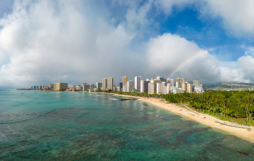 Aerial view of the skyline of Honolulu with Waikiki Beach, the skyscrapers and a rainbow in the background. Panorama with extremely high resolution - Oahu, Hawaii