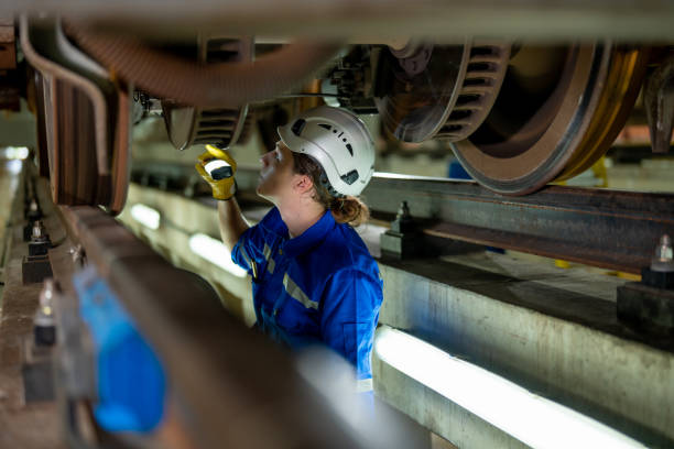 istock Engineer Inspecting Undercarriage of a Train 2126310306