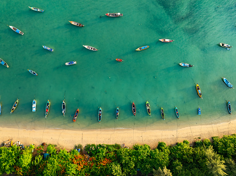 Aerial drone bird's eye view photo Top down of tropical sea with long tail fishing boats Travel boats at phuket thailand, Amazing top view sea nature landscape