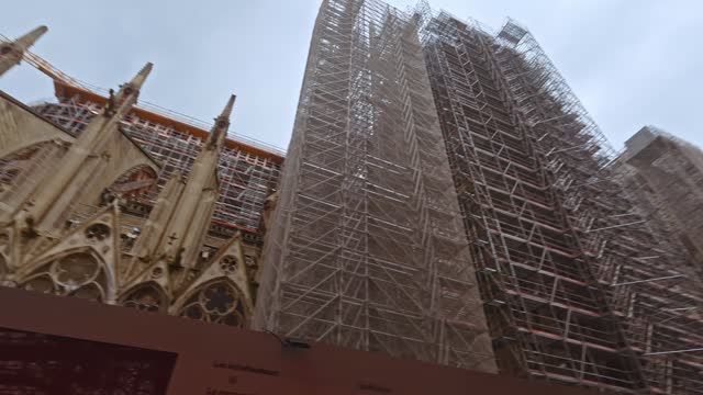 Restoration efforts at notre-dame cathedral in paris on an overcast day