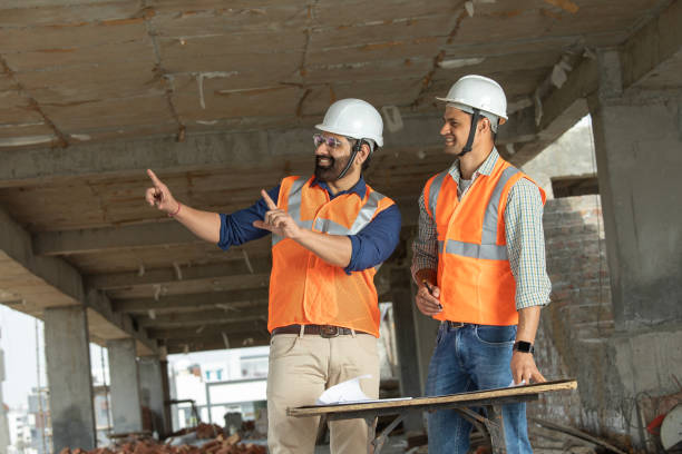 istock Male architects discussing construction details at site 2126483725