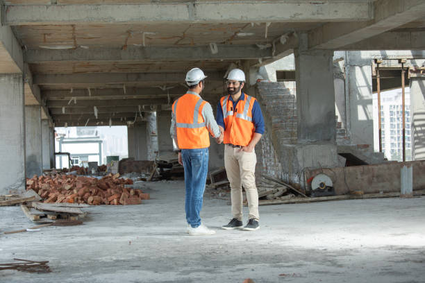 istock Male coworkers shaking hands at construction site 2126504909