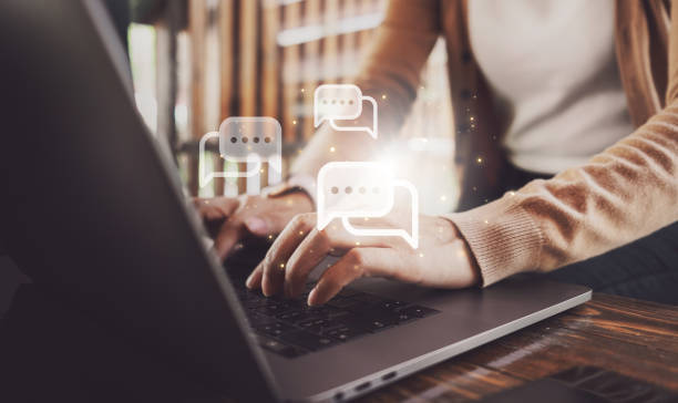 istock Female hands typing on laptop with chat icon. Chatting in facebook, searching working information, browsing.  Technology concept 2126552590
