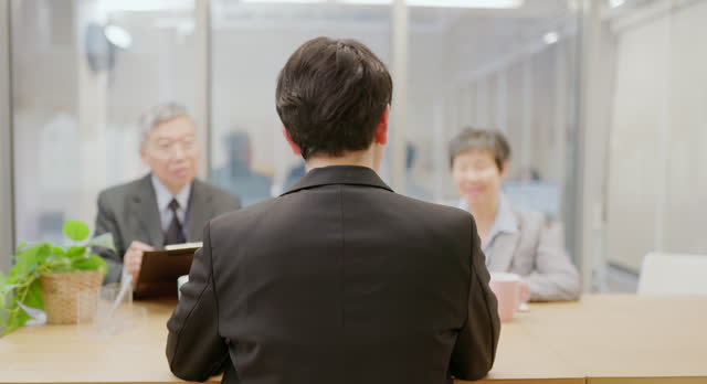 senior executives conduct job interview