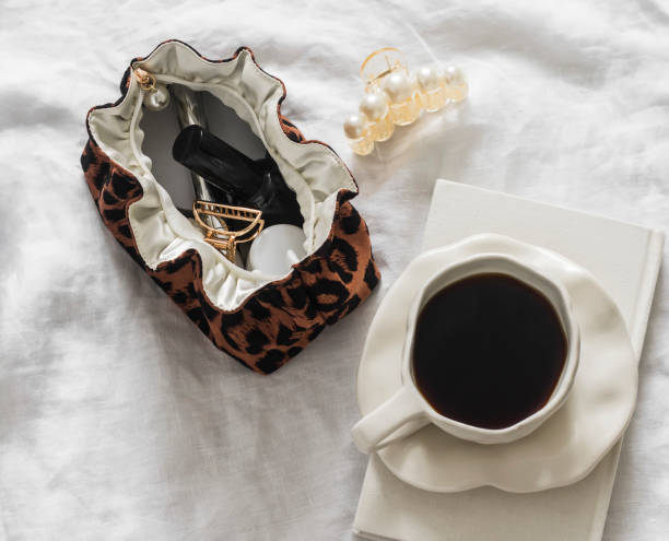 istock A cup of coffee, a notebook, a cosmetic bag on a light background, top view 2126622687