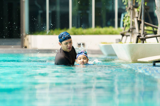 istock Little boy and father enjoy swimming. 2126675148