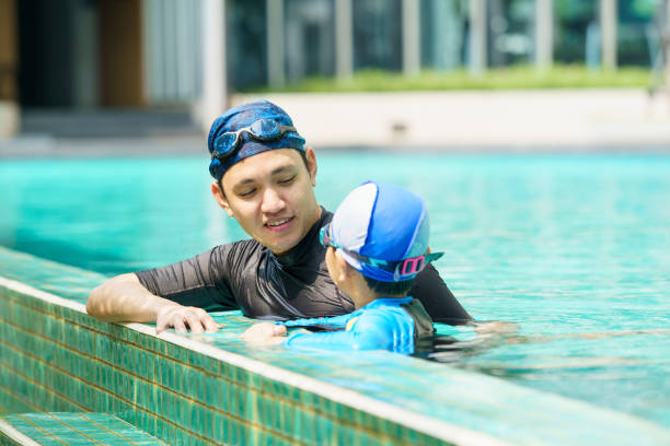 istock Little boy and father enjoy swimming. 2126675159