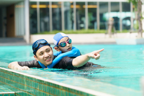 istock Little boy and father enjoy swimming. 2126675160