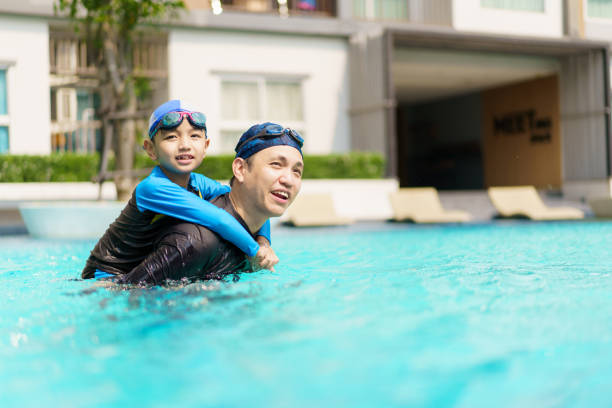 istock Little boy and father enjoy swimming. 2126675175