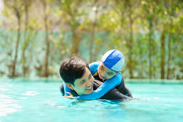 istock Little boy and father enjoy swimming. 2126675257