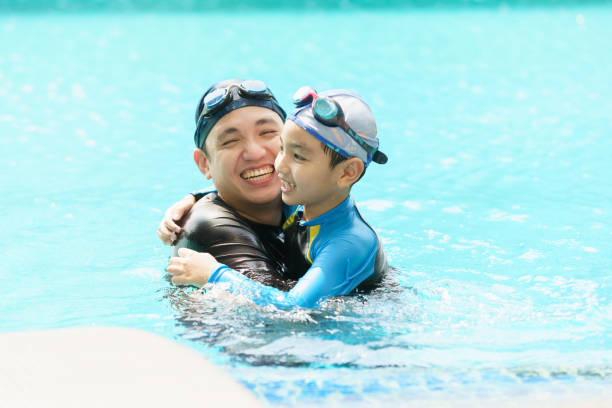 istock Little boy and father enjoy swimming. 2126675264