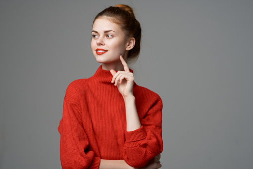 emotional woman in red sweater joy surprise romance model. High quality photo