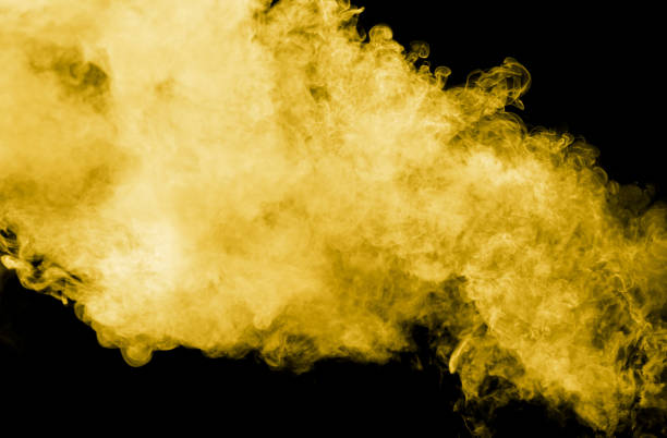 istock Yellow smoke isolated black background 2126764124