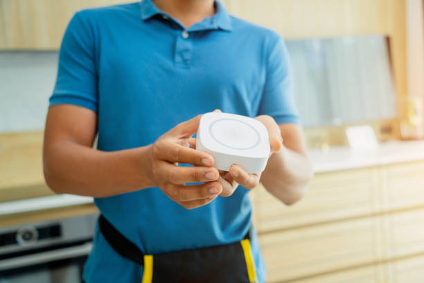 a technician installs a security alarm siren in a modern apartment. - horseback riding flash fotografías e imágenes de stock