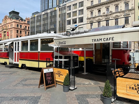 Prague, Czech Republic - March 27, 2024: Cafe Tramvaj on Wenceslas Square in Prague. Old streetcar model converted into a restaurant.
