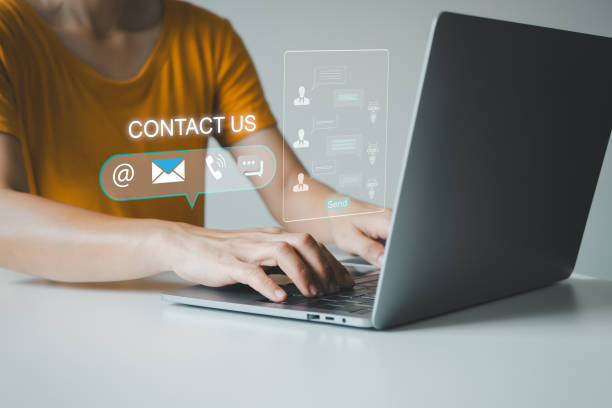 istock Communication and Contact us or Customer support hotline people connect. Hand using a laptop and touching on virtual screen contact icons, email and address, live chat with Ai internet. 2126803618