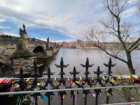 Prague, Czech Republic - March 27, 2024: Locks for lovers attached to the fence.