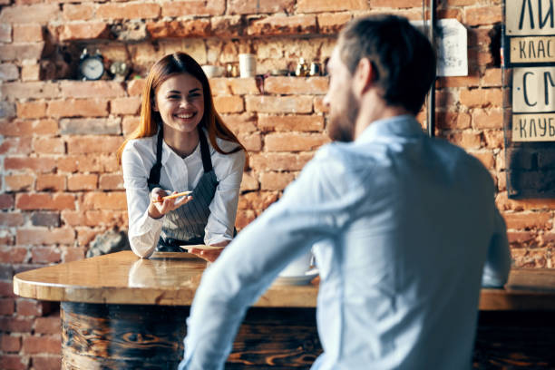 istock female waiter takes an order from a customer service tomorrow 2126821335