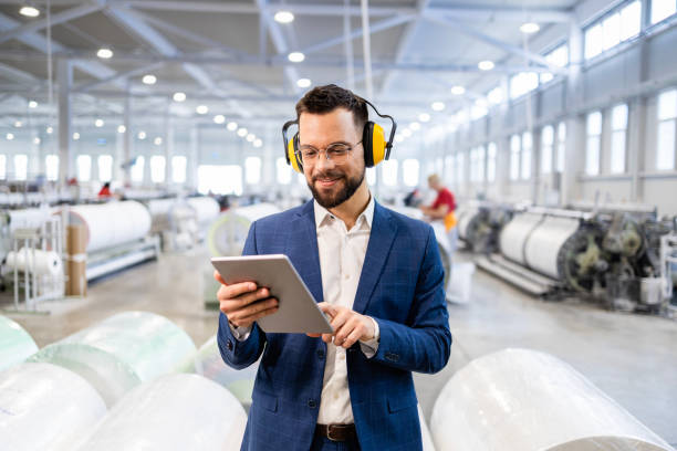 istock Caucasian factory manager standing in production hall and looking statistic on tablet computer. 2126821813