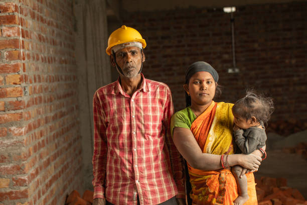 istock Coworkers with girl standing in construction building 2126826514
