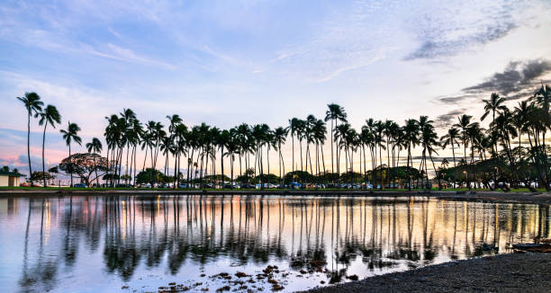 Lahuipuaa on the island of Hawaii.  Hawaiian fish pond used by ancient Hawaiians to hold and breed fish to eat.  Clean, clear Pacific Ocean water with pond backed by blue cloud skies.  Calm pond waters showing palms reflections.  When there one almost can see and feel the ancient Hawaiians energy.